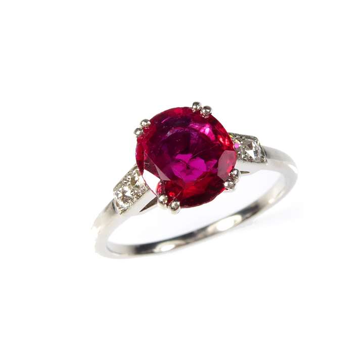 Single stone ruby ring with diamond shoulders